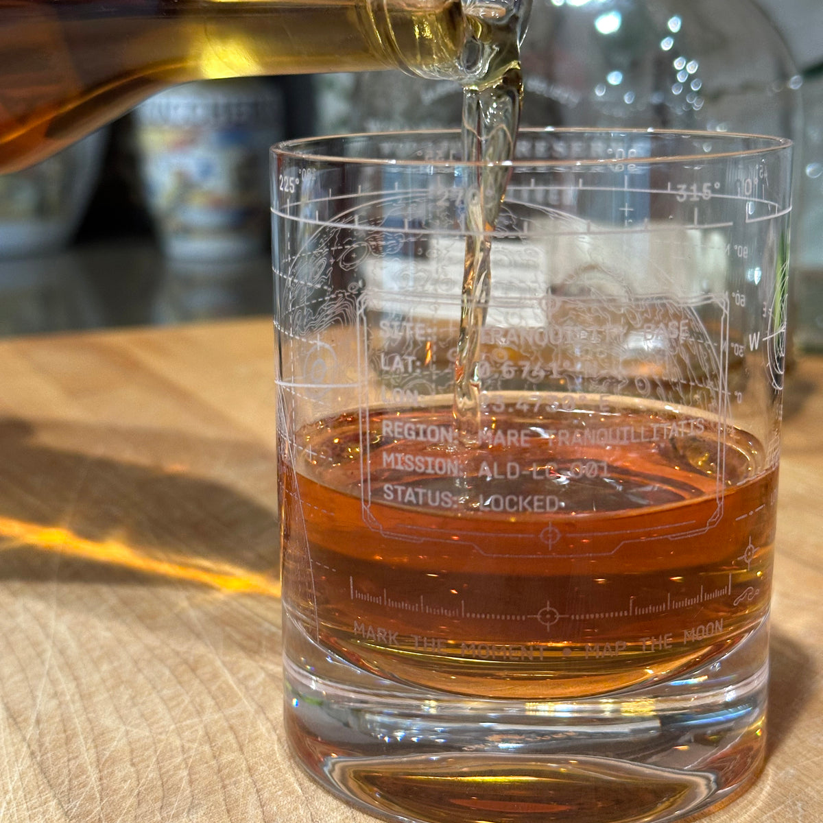 Whiskey being poured into the Vector Lunar Coordinates engraved crystal rocks glass